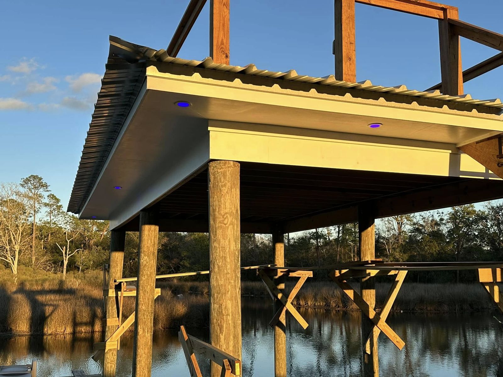 Dock soffit lighting glowing over the water at sunset